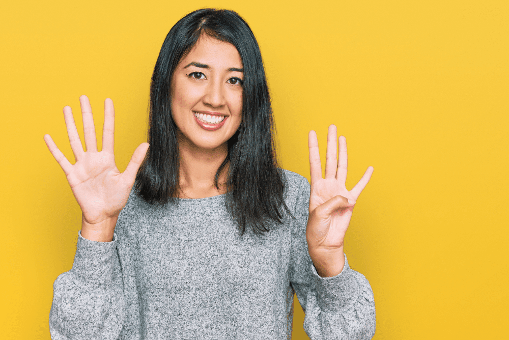 Woman shows 9 fingers to illustrate 9 steps to write a case study